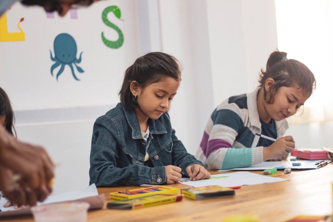 Young learner drawing with colors